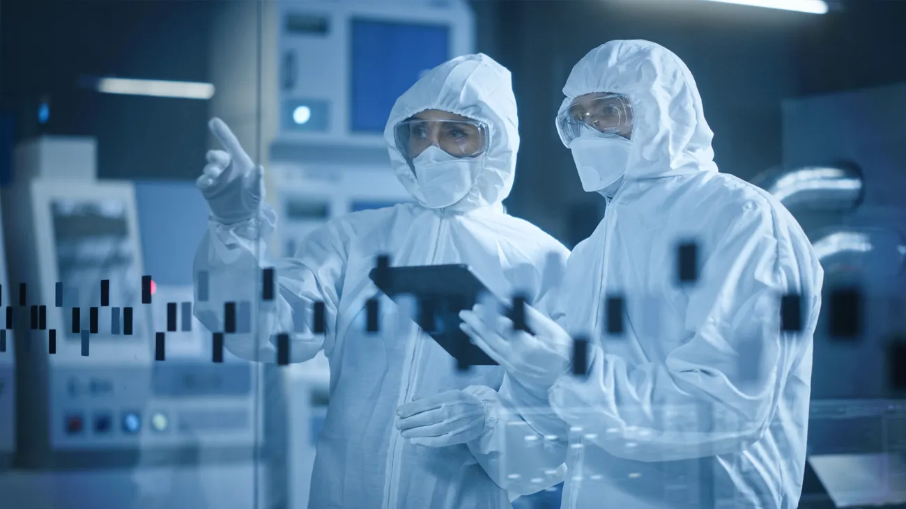 two cleanroom workers observing