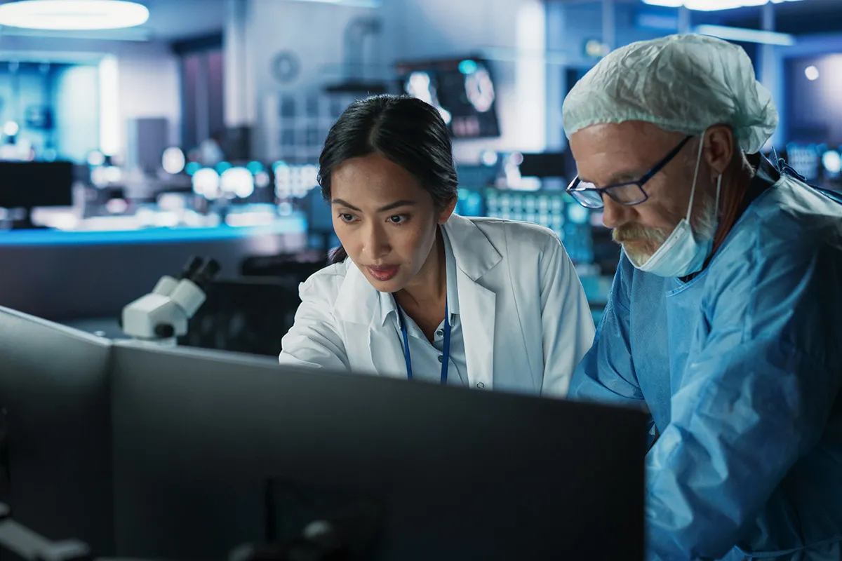 mentor and colleague looking at computer