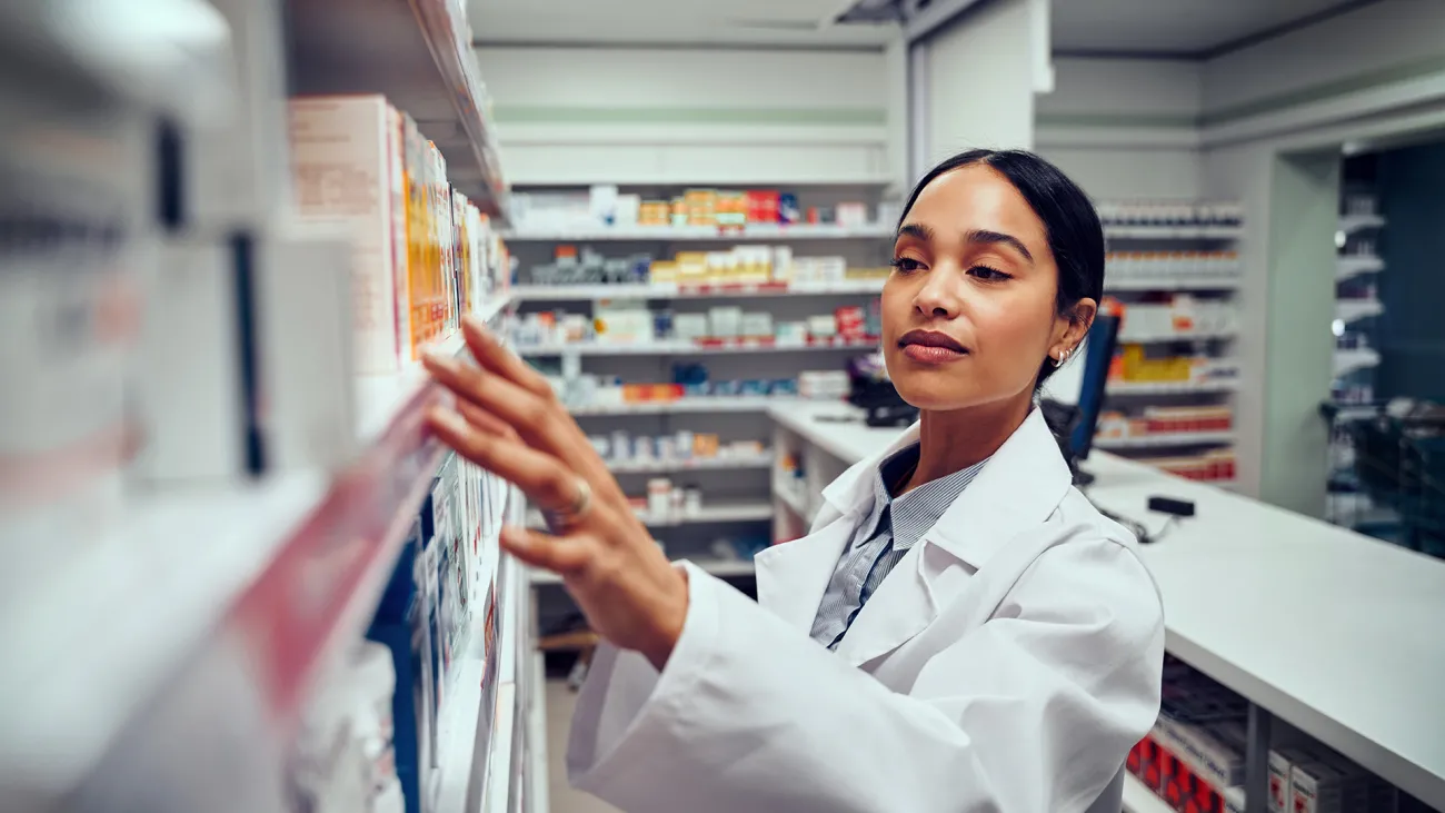 pharmacist looking at shelf