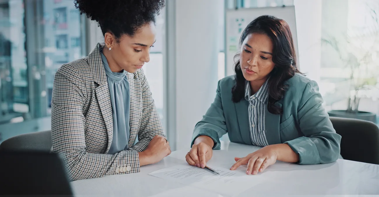 two women looking at contract